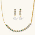 Gold-plated jewelry set with green cubic zirconia floral motifs, featuring matching necklace and pearl drop earrings